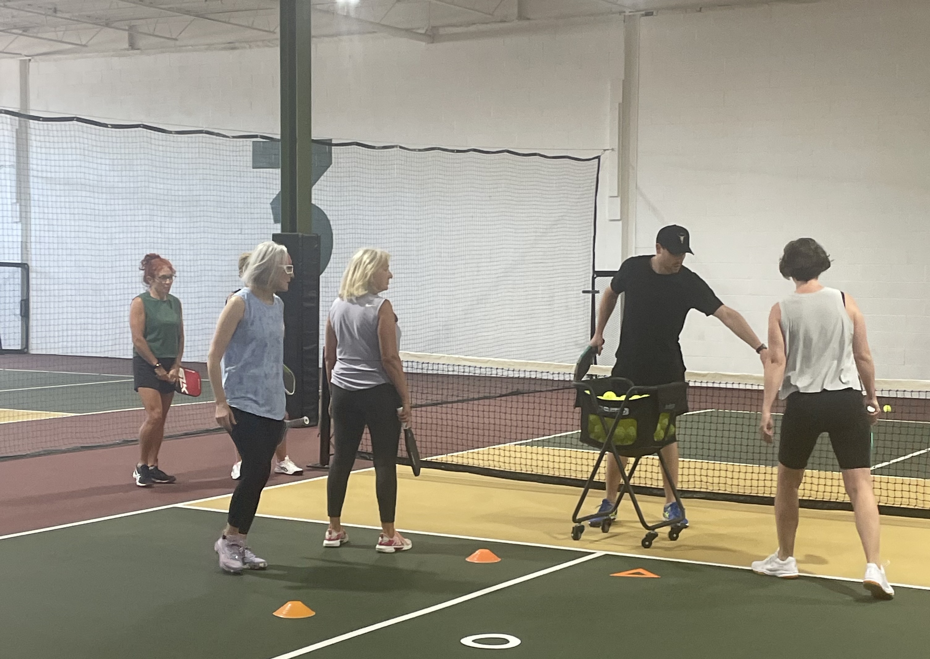Coach demonstrating pickleball drills to intermediate 3.0–3.5 players